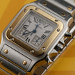 A Cartier watch with a silver-toned stainless steel case and bracelet, a gold-toned bezel, and a white dial with Roman numerals, set against a yellow background.